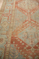 Close-up of the textured weave and even wear on a Heriz runner's geometric pattern.