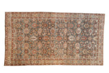 Distressed Mahal rug runner with an allover floral design in oxidized silver, raspberry red, and brown.