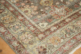 Corner of a distressed Mahal rug showing low-pile texture, visible knot heads, and a floral border.
