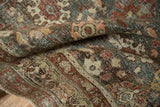 Low pile and hand-knotted texture of a distressed Mahal rug with pomegranate and floral motifs.