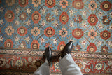 Distressed vintage Veramin carpet contrasting the blue Mina Khani field with the intricate red Herati border.