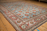 Vintage Veramin carpet's ornate red Herati border alongside its powder blue Mina Khani floral field.
