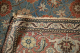 The reverse hand-knotted weave and end fringe of a vintage Veramin carpet's folded corner.