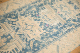 Geometric blossoms in dusty teal and cream with fuchsia accents on a distressed vintage Persian runner.