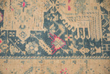 Hand-knotted pile of a distressed Persian runner with fuchsia blossoms and denim blue patterns.
