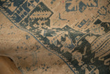 Textured surface of the distressed Persian rug showing wear down to the knot heads.