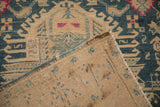 A folded corner of the vintage Persian runner reveals its hand-knotted foundation and side cord.