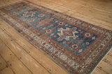 Angled view of the distressed Malayer runner showing its single column of geometric medallions.