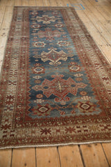 Lengthwise perspective showing the flow of geometric medallions on a distressed Malayer runner.