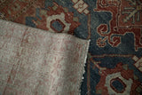 Corner view of the distressed Persian Malayer rug's hand-knotted foundation and machine-bound side.