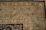 Corner detail of a vintage Kerman rug with Rococo spandrels and floral arabesque borders.