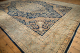 Rococo-style corner spandrel and wide floral border on a vintage hand-knotted Kerman carpet.