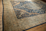 Rococo stylized corner spandrels and floral arabesque border on a Persian Kerman carpet.