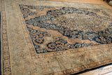 Angled view of the vintage Kerman's Rococo spandrels against the dense navy mil fleur patterned field.