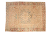 Vintage distressed Ahar carpet with a central medallion in sand, dusty blue, and pomegranate red.