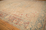 Heavy abrashes and worn pile on a vintage Ahar carpet in sand, blue, and red tones.