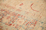 Detail showing the worn texture and abrashes on a distressed vintage Ahar carpet.