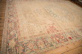 Angled view of the large Persian Ahar carpet, emphasizing its decorative distressed wear and neutral ground.