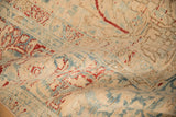 Low, hand-knotted pile of a distressed Ahar carpet with sand, dusty blue, and pomegranate red accents.