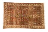 Vintage distressed Bakhtiari carpet with a paneled four seasons garden motif in rust, ivory, and green.