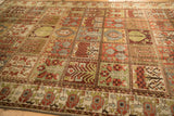 Angled view of the distressed texture and colorful paneled design on a vintage Bakhtiari carpet.