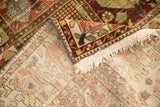 The hand-knotted foundation, back weave, and fringe on a vintage Bakhtiari carpet corner.