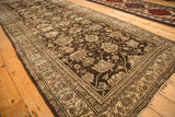Angled perspective showing the intricate pattern and texture of a distressed antique Bijar runner.