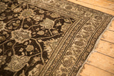 Worn corner of a Persian Bijar runner with chocolate brown and ivory palmette designs.