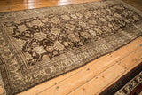 Angled perspective on an antique Bijar runner's low pile and diagonal allover palmette pattern.
