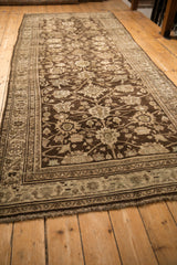 Long view of the antique Bijar runner's allover palmette design in brown and beige tones.