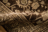 A close view of the antique Bijar rug's low pile, even wear, and rich chocolate brown colors.