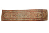 Antique Northwest Persian rug runner with triple medallions over a seeded lattice field in sand, red, and blue.