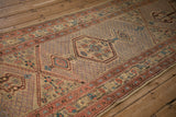 Perspective view of the antique runner's geometric medallion, seeded lattice field, and detailed borders.