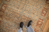 Decorative distressed texture of a vintage Bijar runner with sky blue and terracotta Herati pattern.