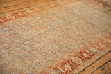 Angled view of the vintage Bijar runner's low-pile Herati pattern and wide terracotta floral border.