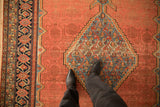 Low pile texture on an antique Malayer carpet, detailing its stepped blue medallion and geometric border.