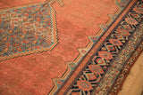 Antique Malayer carpet corner showing the tone-on-tone shadow field and geometric pomegranate border.