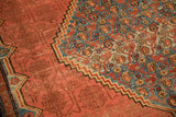 Stepped medallion edge separating blue floral motifs from the red tone-on-tone shadow-patterned field.