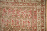 Detail of the antique Malayer rug's boteh pattern showing wear down to the knot heads.