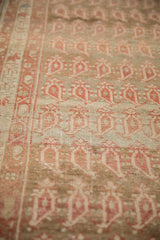 Hand-knotted texture and mostly even wear across the boteh motifs of a distressed Malayer runner.