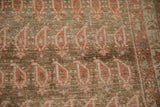 Detail of staggered boteh designs showing distressed wear to the knot heads on the antique runner.