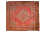 Vintage Oushak square carpet with a geometric medallion and starburst florals on an abrash red field.