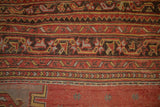 Mostly even wear showing the knot heads and geometric patterns of a vintage Turkish Oushak carpet.