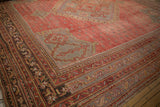 Corner of a vintage Turkish Oushak carpet with serrated geometric borders in saffron and slate blue tones.