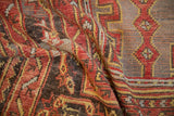 Textural low pile of a vintage Oushak rug with even wear, showing pomegranate red and saffron yellow hues.