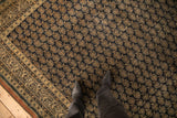 Antique Tabriz carpet corner with navy boteh field and ivory checkered scrolled vine border.