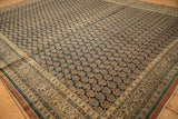 Detailed view of antique Tabriz's checkered scrolled vine border and staggered boteh motifs.