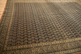Antique Tabriz carpet: navy field, diagonal boteh with finned characters, vine border detail.