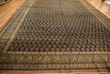 Antique Persian Tabriz carpet border detail with checkered vine, blossom, and pawn motifs.