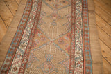 Wide natural camel hair border and intricate geometric interior of an antique Persian Serab runner.